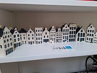 Front view of complete set of eleven porcelain KLM Delft houses arranged in a row