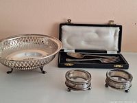 Lot showing entire set including silver bowl, two salt and pepper dishes, and child's fork and spoon in box.