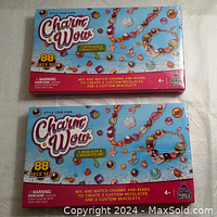 Photo of two identical Charm Wow craft kits, each sealed in shrink wrap with colorful packaging showing jewelry creations and 88-piece set details