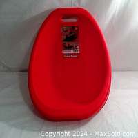 Front view of the red scoop floor rocker showing its shape and handle with original tag attached.