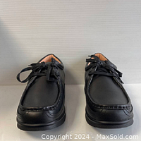 Front view of men's black leather casual loafer shoes showing lace-up design and double stitching.