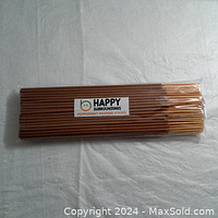 Top view of 100 peppermint incense sticks bundled together in transparent packaging with Happy Surroundings label.