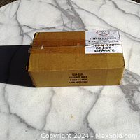 Closed cardboard box labeled with product details and quantity (1000 units).