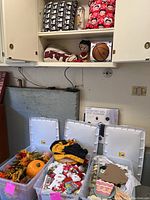 Same bins showing autumn decor and linens, with pink price tags on bins.