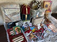 Full view of the household bundle showing bedding, assorted toys, kitchen items, decorative wreath, and wall art.