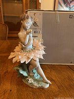 Front view of Lladro figurine with original box showing label