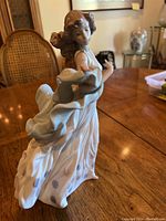 Full front-left side view of figurine on wooden table