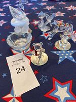 Overview of all Swarovski crystal figurines on tabletop with patriotic star tablecloth.