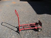 Full view of the red heavy-duty hand truck in cart configuration with flat base, showing new wheels and metal frame.