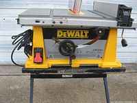 Side view showing DeWalt logo, power switch, handwheel and taped power cord