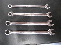 Four Snap On metric combination wrenches arranged side by side showing both open and boxed ends.