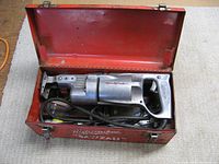 Milwaukee Sawzall in open red metal case, solid metal body, corded, vintage condition