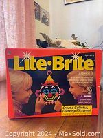 Original boxed Lite-Brite set from 1994 with graphics showing children creating a lighted clown image with pegs