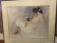 Framed gallery poster featuring R.C. Gorman's 'Laila with Child' artwork with watermark reflection from light and visible crack on glass and warp on matte at lower bottom right.