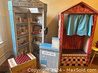 Front view of corner store and theatre play set with visible contents