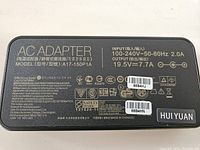 Close-up of AC adapter label with electrical and safety specifications.