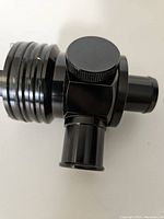 Top and side views of black anodized aluminum blow off valve showing adjustable cap and multiple ports
