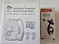 Photo showing Bellababy wearable breast pump replacement parts box with illustration of parts included and Mombella Dancing Elephant teething toy box