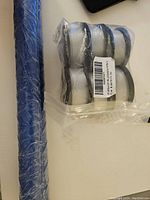 Close-up of trimmer line spool packages in plastic wrapping and blue rolled pad