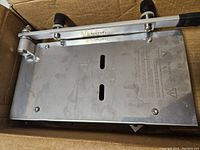 Top view of the stainless steel base of the manual frozen meat slicer with brand marking Befen visible and adjustment knobs.