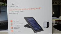Original product box showing Wasserstein solar panel compatible with EufyCam E, highlighting eco-friendly, 360-degree rotatable bracket, quick installation, and weather resistance features.