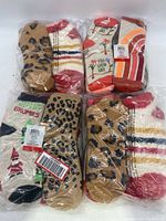 Four packs of assorted women's socks in plastic packaging showing various colors, patterns and designs