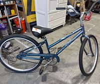 Full side view of blue Fuji Captiva cruiser bike showing frame, tires, seat and handlebars.