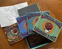 Overhead view of box set open showing three disc sleeves and lyric sheet