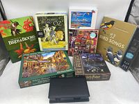 Full lot view showing all puzzles, bird books, and playing card set