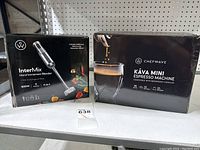 Both appliance boxes shown side by side on shelf, clearly showing brand and product names.