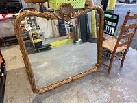 Full view of the large rectangular wooden framed mirror showing carved details and condition