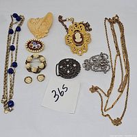 Top-down photo of all jewelry pieces showing their relative sizes and details.