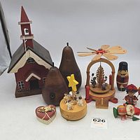 Photo showing all wood decor items grouped together including church, pears, music boxes, and figurines.