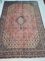 Full front view of rug showing overall pattern, border and medallion design