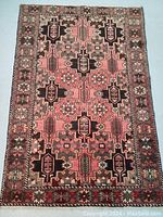 Full view of rug showing overall pattern, color and border design