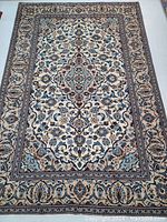 Full top-down view of entire rug laid flat showing pattern, border and color scheme