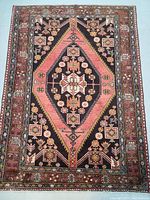 Full view of geometric medallion Persian rug