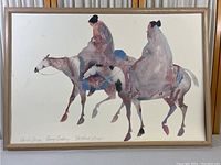 Full view of the framed lithograph print showing two robed figures on horses, signed by Carol Grigg at the bottom edge.