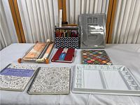 Overview of the crafting collection including colored pencils, paper cutter, journals, planners, and palette tray.