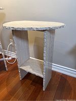 Full side view showing the marble stand's base and separate top with rough cut edges