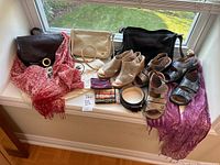 Wide view of entire lot showing shoes (sandals), purses, scarves, belts, and small coin purses displayed on window ledge