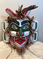Front view of mask showing full painted design and fiber trim