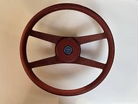 Full view of the vintage red Camaro Type LT steering wheel showcasing its circular shape and three-spoke design.
