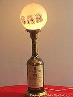 Full view of the lamp showing the Seagram's V.O. glass bottle base and illuminated globe with BAR lettering.