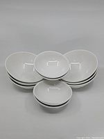 10 white ceramic Steelite International Albalite bowls stacked; 4 smaller appetizer/dessert bowls and 6 medium soup/salad/pasta bowls