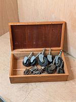 Wooden box containing 13 assorted vintage castor wheels, metal and plastic types.