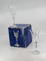 Two Eaton lead crystal liquor glasses shown next to original blue box with visible text and wear.