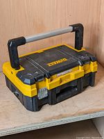Front view of Dewalt TSTAK I Organizer Top toolbox showing folding handle and Dewalt branding.