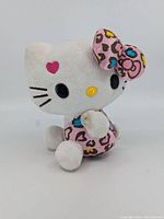 Front-left angled view showing face, bow, and outfit pattern