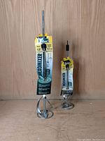 Two Richard Hexomixer paint mixers standing upright in original packaging, one larger and one smaller, showing scale and packaging details.